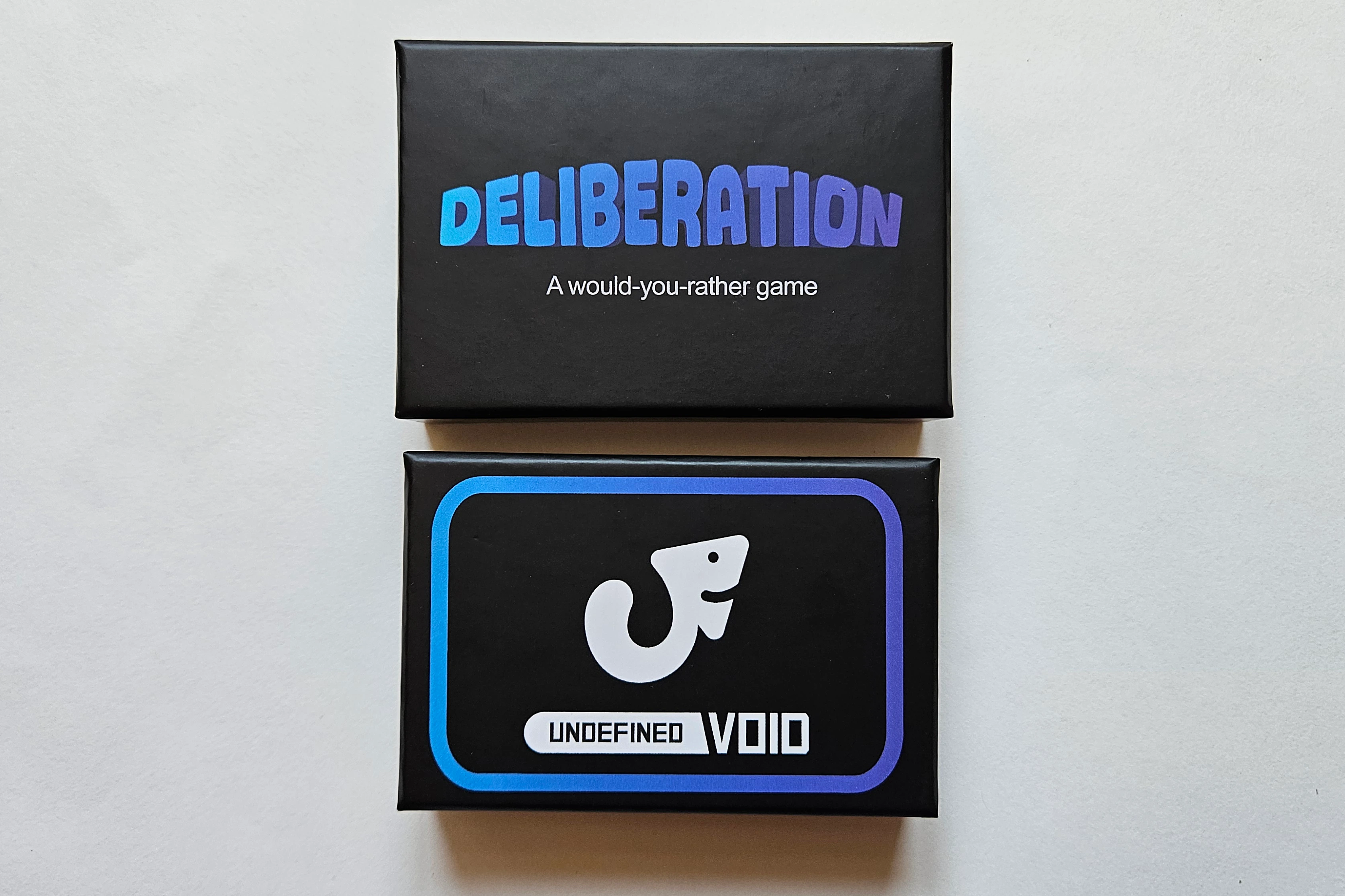 Deliberation card game box showing top and bottom sides of packaging