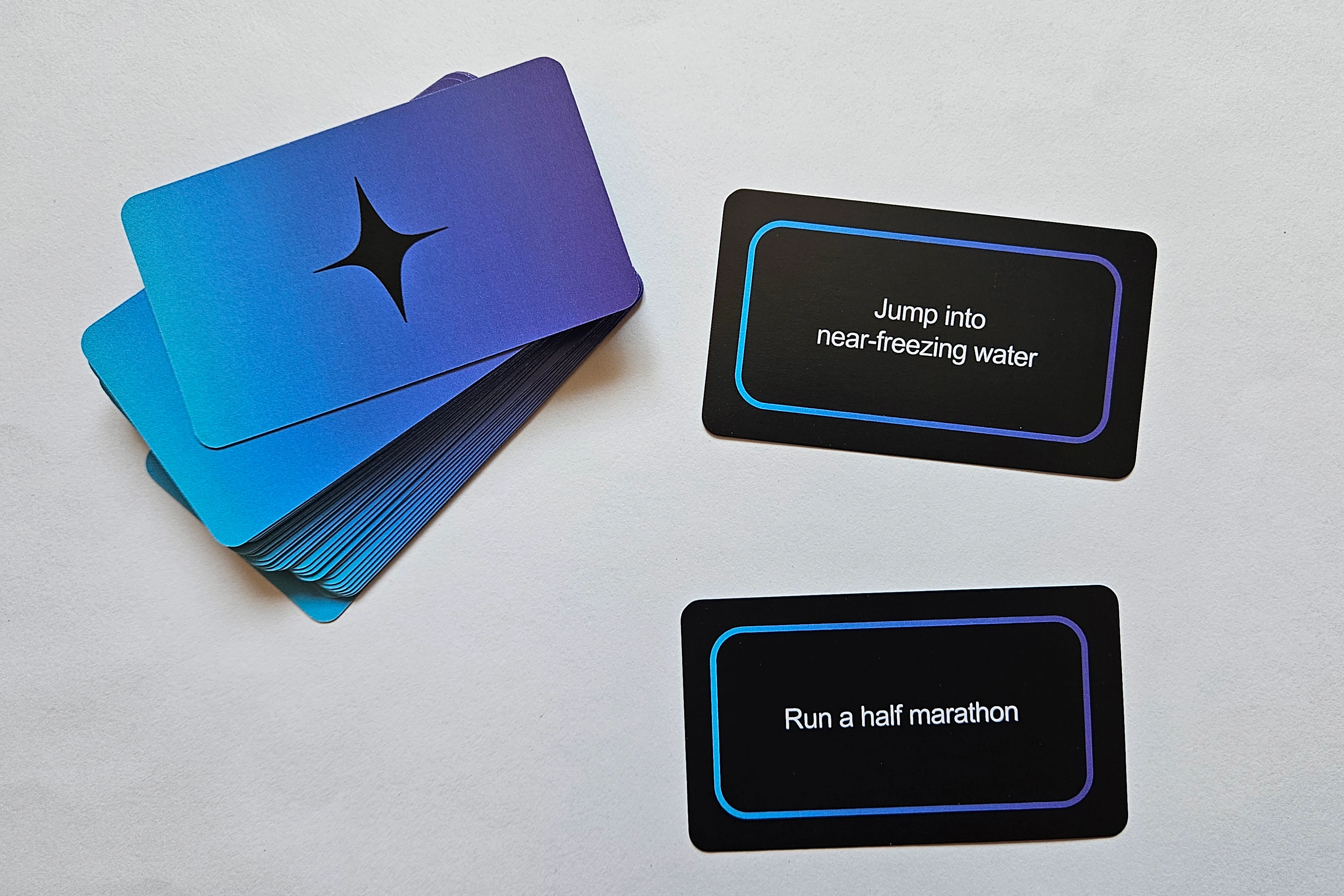 Deliberation card game deck with two would-you-rather scenario cards on the table